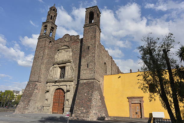 View of catholic church Santiago de Tlatelolco built in baroque style by Spanish between 1604 and 1610. Picture taken at the Plaza de las Tres Culturas (Square of the Three Cultures) in Mexico City, location: N19 27.057 W99 08.255