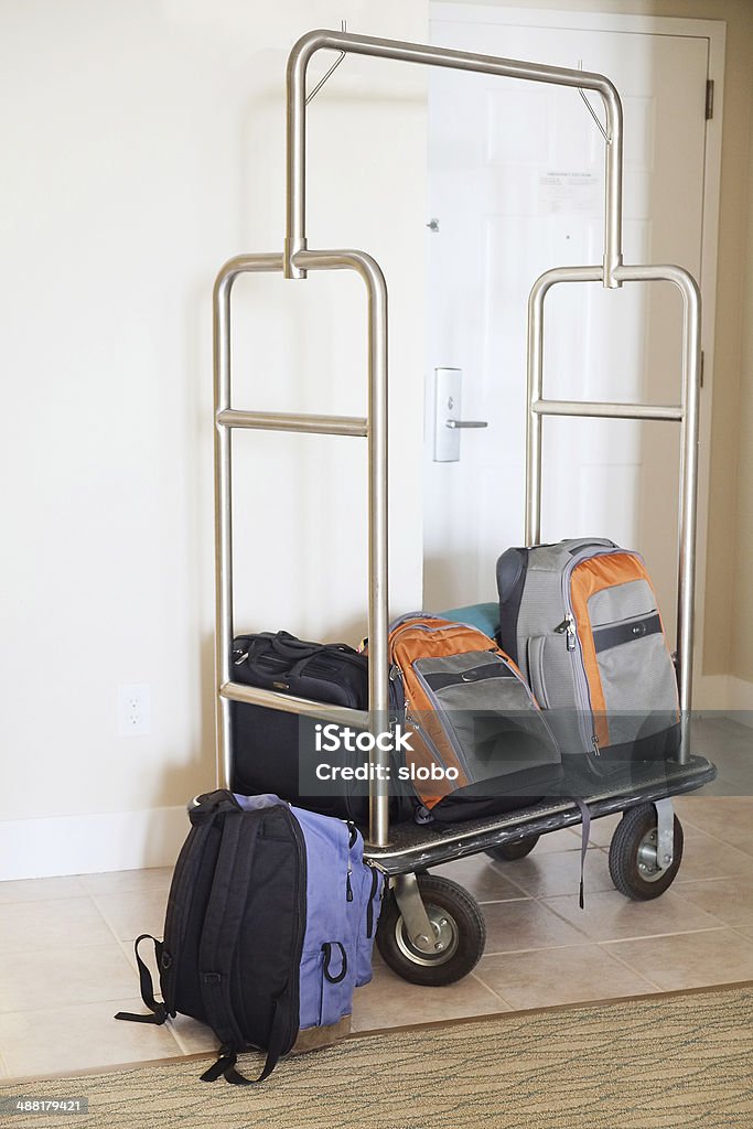 Luggage on a Cart Stacked luggage on a cart inside hotel room. Bag Stock Photo