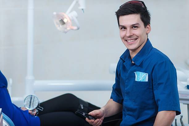 istock Dentist curing a female patient 488180871