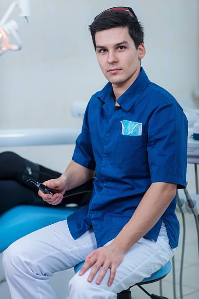 istock Dentist curing a female patient 488180873