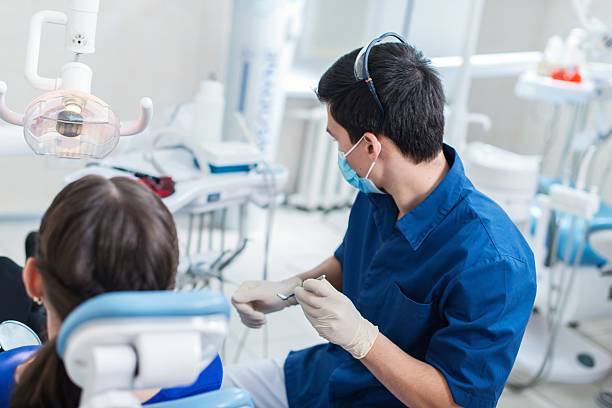istock Dentist curing a female patient 488180923