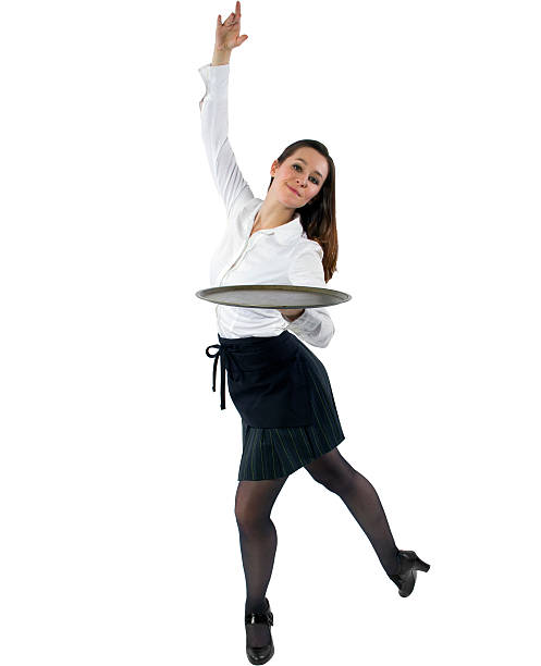 Cheerful waitress with desserts looking at camera and smiling. Customers sitting in background.