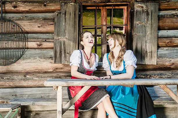 Two cheerful women in traditional austrian outfit