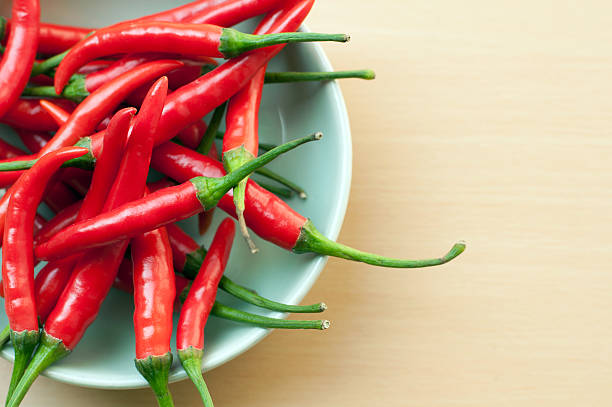 istock Bowl of hot chilli peppers with copy space 488201071