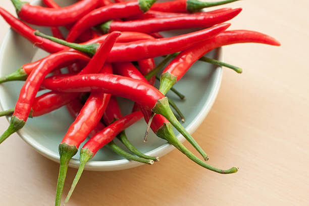 istock Bowl of hot chilli peppers with copy space 488201075