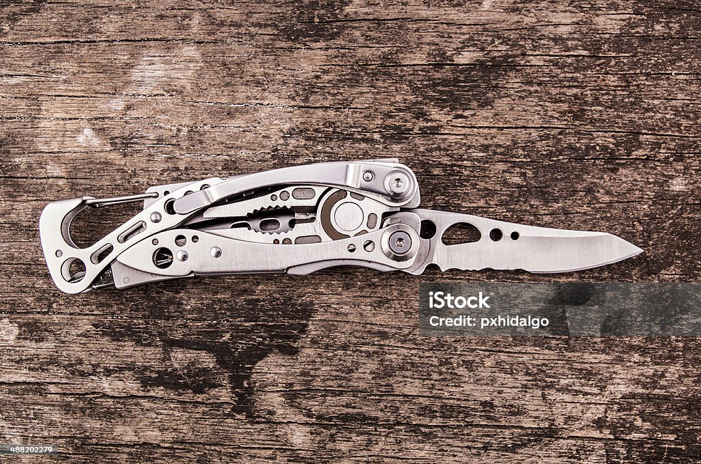 multitool, multi purpose tool with plyers and knife leatherman tool knife in the wood Accessibility Stock Photo