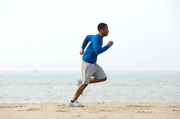 istock Young male jogger exercising at the beach 488202497
