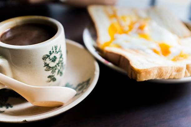 Croissant with ham and cheese. Cup of coffee. Closeup. Ham cheese scrambled eggs croissant for breakfast. toning