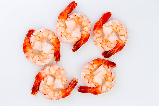 Ten Cooked Cocktail Tiger Shrimps Ten cooked cocktail tiger shrimps are partnered with eachother to create ying yang design black tiger shrimp stock pictures, royalty-free photos & images