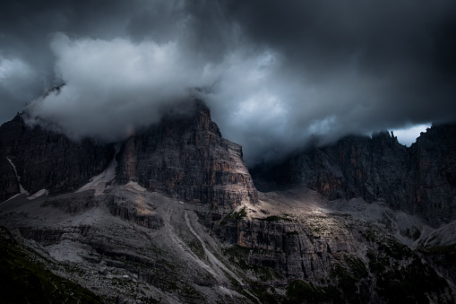 Rock wall of the dolomites with fog