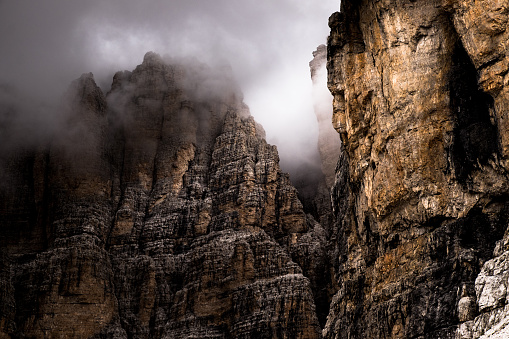 Rock wall of the dolomites with fog