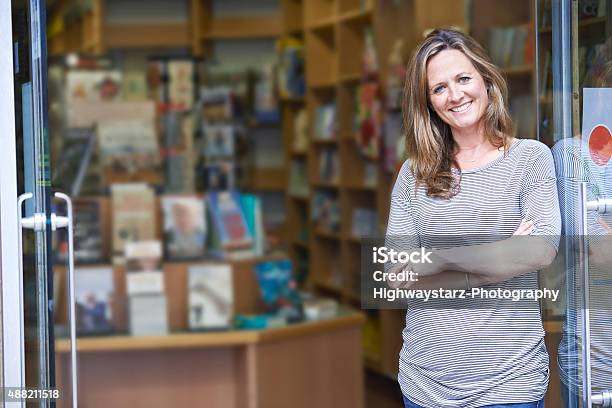 Portrait Of Female Bookshop Owner Outside Store Stock Photo - Download Image Now - Bookstore, Owner, Store