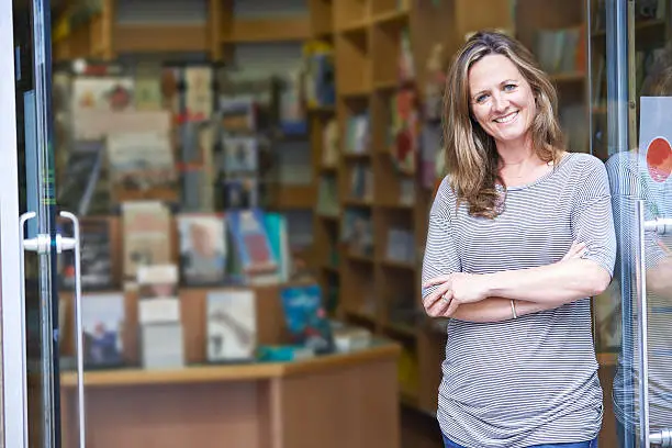Photo of Portrait Of Female Bookshop Owner Outside Store
