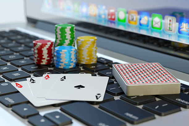 Online poker, virtual casino and gambling concept Four aces, deck of playing cards and colorful chips on computer laptop keyboard texas hold em photos stock pictures, royalty-free photos & images