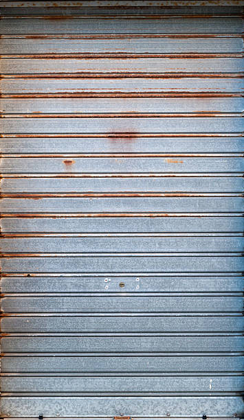 istock Steel rolling shutter of closed door, texture 488213262