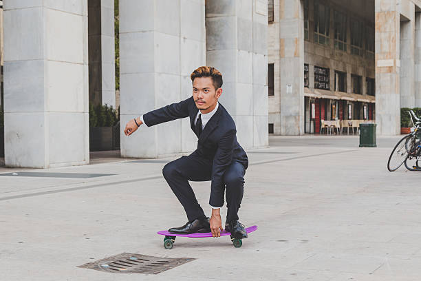istock Young handsome Asian model posing with his skateboard 488214384