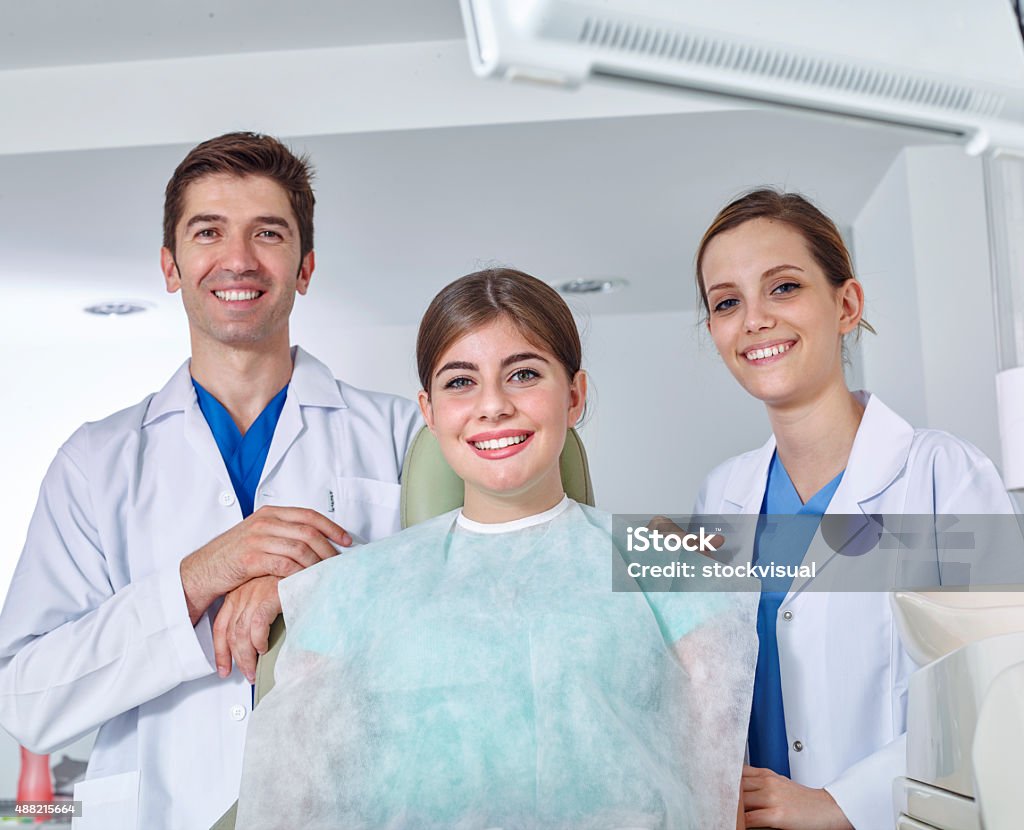 Dentist, assistant and young woman similing for the camera Dentists and young woman 2015 Stock Photo