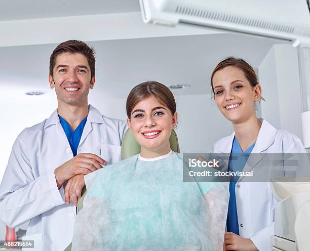 Dentist Assistant And Young Woman Similing For The Camera Stock Photo - Download Image Now