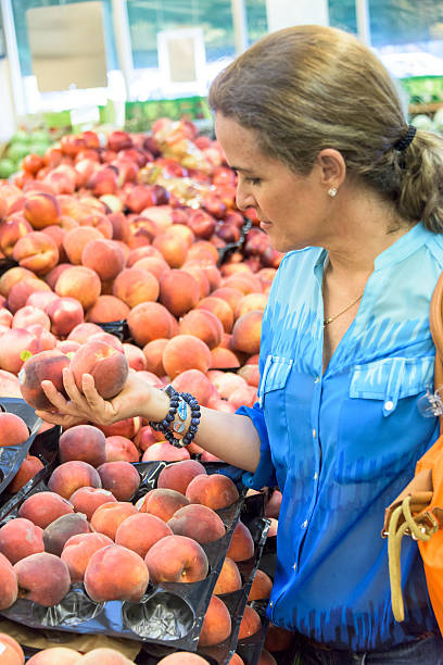 istock Housewife buying peaches 488217482