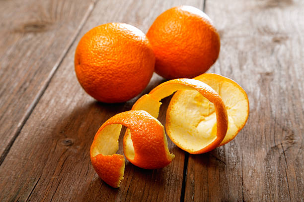 istock Oranges and dried peel on a rural table 488218567