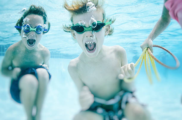 children screaming underwater playfully - baby swim under water bildbanksfoton och bilder