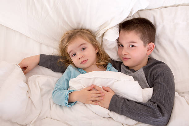 istock Affectionate young brother and sister lying in bed 488221665