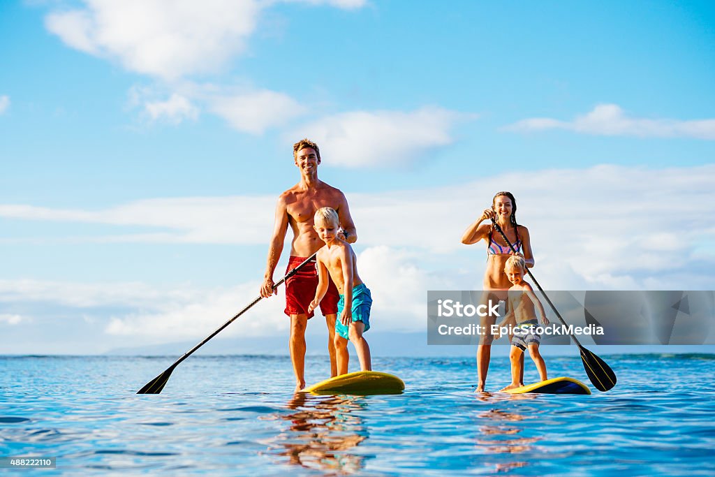 Family Fun, Stand Up Paddling Family Having Fun Stand Up Paddling Together in the Ocean on Beautiful Sunny Morning Family Stock Photo