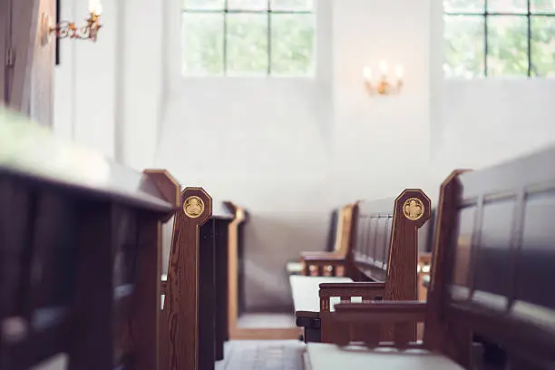 Two rows of benches in a church