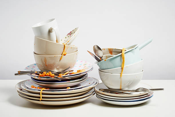 Dirty dishes pile needing washing up on white background Dirty dishes pile needing washing up. Household chore concept on white background stack of dishes stock pictures, royalty-free photos & images