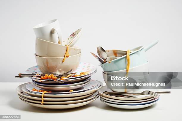 Dirty Dishes Pile Needing Washing Up On White Background Stock Photo - Download Image Now