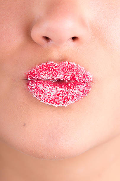istock Cropped image of woman lips covered with sugar 488223753
