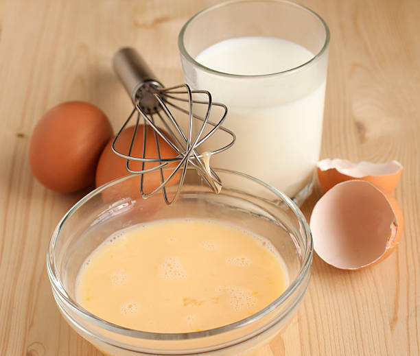 istock Beat eggs with milk in a glass bowl 488224977