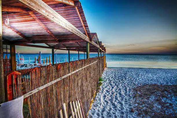 wooden cabin by the sea at sunset, Sardinia