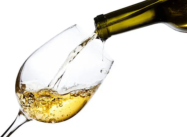 sweet  wine being poured into a wineglass, isolated  on white background