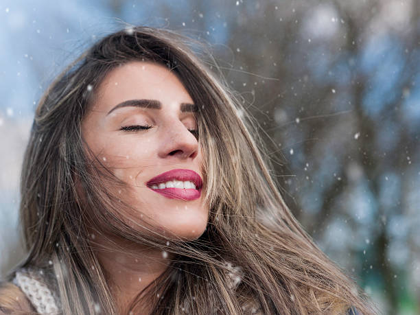 istock Girl enjoying snow with eyes closed 488239454