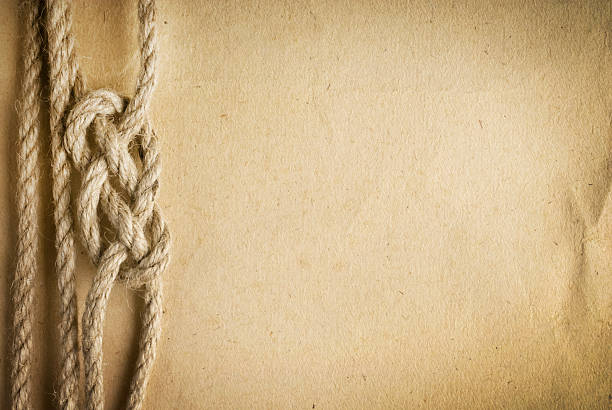 istock aged Rope on the old paper background 488239975