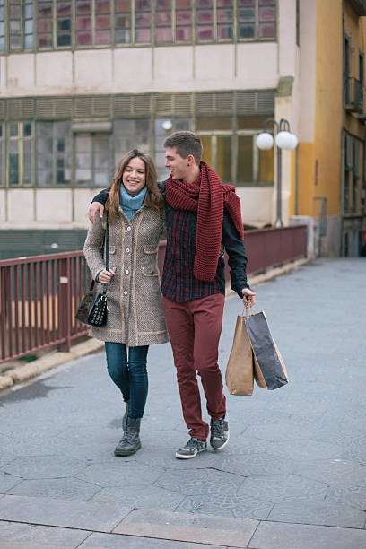 istock Couple walking along after shopping 488241324