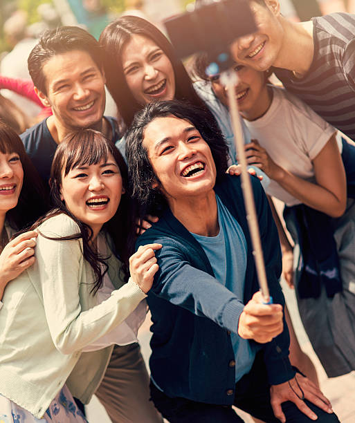 istock Happy japanese friends taking a selfie 488242192