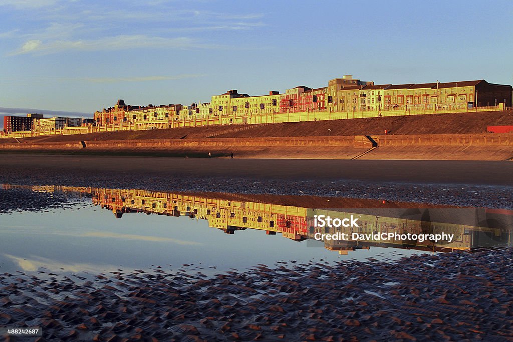 The Golden Mile Golden hour sunshine reflected on a tidal pool showing Blackpool North Shore at its finest. Beach Stock Photo