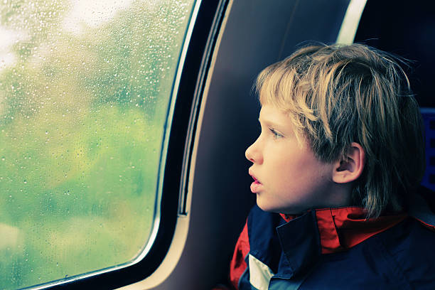 istock 7 years old boy sitting in the train 488244054
