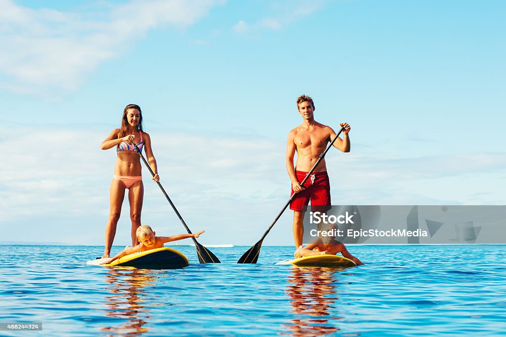 Family Fun, Stand Up Paddling Family Having Fun Stand Up Paddling Together in the Ocean on Beautiful Sunny Morning Family Stock Photo