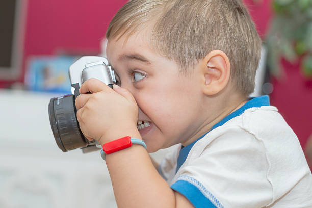 istock Child (3 years old) taking picture with toy camera 488244942