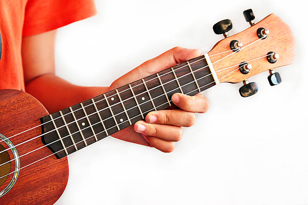 istock girl playing Ukulele , close up in hands 488245127