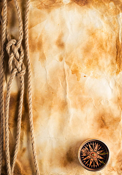 istock Rope and compass on the old paper background 488245467