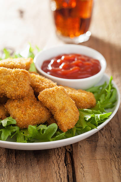 istock fast food chicken nuggets with ketchup, cola 488245628