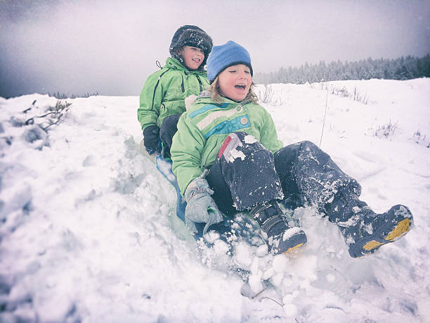 istock Children sledding together in snowy weather 488245766