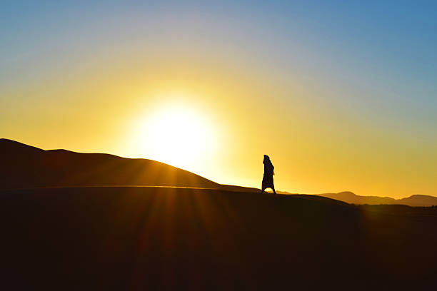 istock Moroccan man enjoying sunset in Sahara Desert 488246342