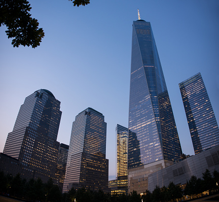 One World Trade Center and other skyscrapers in the Financial District, Lower Manhattan, New York City. Night view of Lower Manhattan and its modern skyscrapers in New York. Illuminated skyscrapers in the Financial District of New York City.