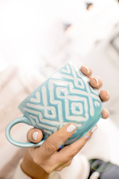istock Women hand holding cup of tea 488247472