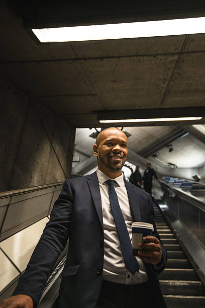 istock Businessman with coffee mug on the london subway 488247636